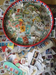 A huge pile of used postage stamps